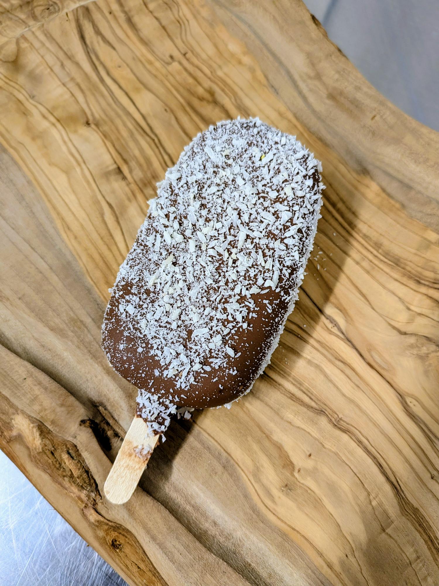 3 Creamy coconut ice cream lolly with chocolate coating, dusted with toasted coconut